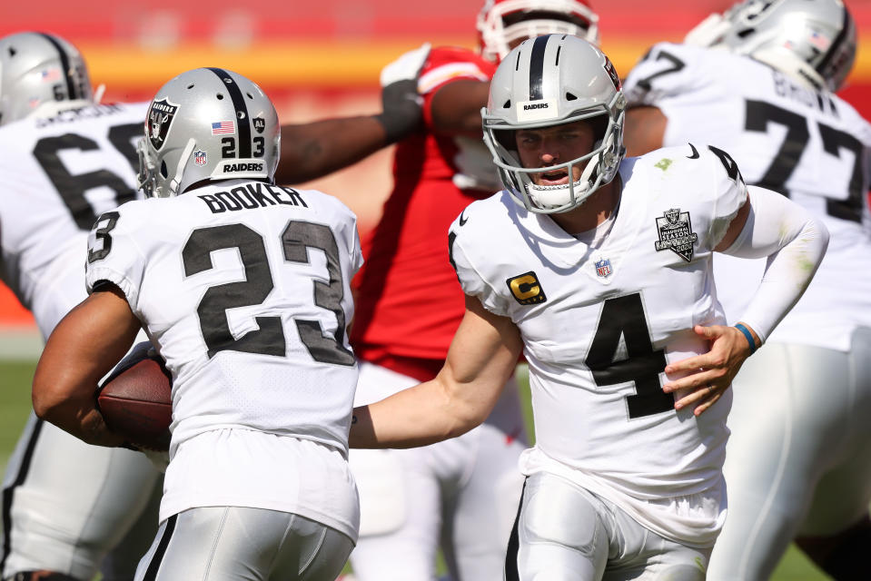 Derek Carr hands the ball off to Devontae Booker.