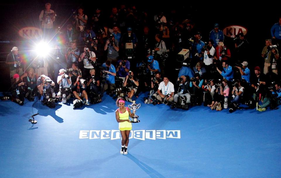 Serena Williams of the U.S. poses the trophy after defeating Maria Sharapova of Russia in the women&#39;s singles final at the Australian Open tennis championship in Melbourne, Australia, Saturday, Jan. 31, 2015. (AP Photo/Rob Griffith)