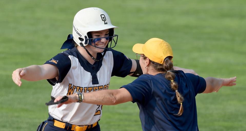 Karlei Conard was all smiles greeted by the assistant first base coach Audra VanBrandt after driving in 2 runs in the fifth inning as the Bobcats beat Laingsburg 8-0 in the Division 3 state semifinals at Seehia Stadium, MSU Friday, June 16, 2023.