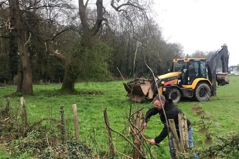 A local resident in a stand-off with contractors trying to create a new access point through the fence line onto a field next to Leigh Woods  to create a 700 plot Roots Allotments