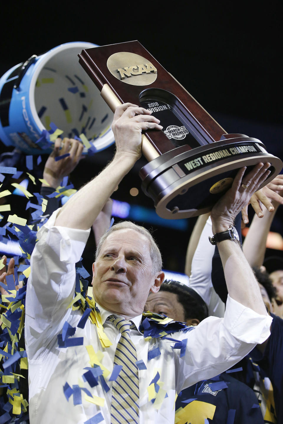 FILE - Michigan head coach John Beilein celebrates after beating Florida State in an NCAA college basketball tournament regional final in Los Angeles, March 24, 2018. Roy Williams and Jim Calhoun will join John Beilein and Lon Kruger in a star-studded cast of coaches who will be inducted into the National College Basketball Hall of Fame in November. (AP Photo/Alex Gallardo, File)