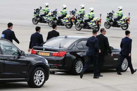 Bodyguards escort the car of Chinese President Xi Jinping after his arrival at the airport in Hong Kong, China, ahead of celebrations marking the city's handover from British to Chinese rule, June 29, 2017. REUTERS/Bobby Yip