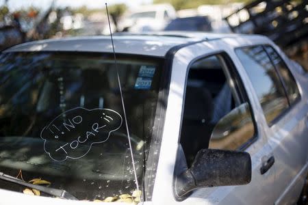 One of the cars used by drug lord Joaquin "El Chapo" Guzman to escape before he was recaptured on Friday, is pictured inside a car impound lot in Los Mochis, in Sinaloa state, Mexico, January 10, 2016. The writing on the windshield reads "Do not touch". REUTERS/Edgard Garrido