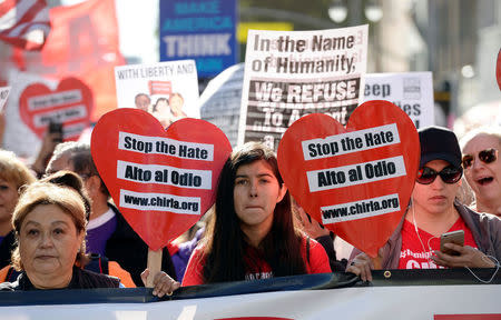 Protesters hold up signs during a march and rally against the United States President-elect Donald Trump in Los Angeles, California, U.S. December 18, 2016.REUTERS/Kevork Djansezian