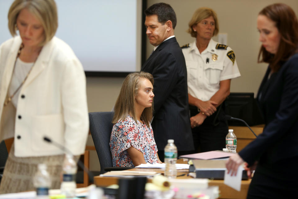 TAUNTON, MA - JUNE 13: After a sidebar with Judge Lawrence Moniz, attorney Joe Cataldo, standing center, returns to the defense table with his client Michelle Carter, seated, before resting his case in Bristol Juvenile Court in Taunton, MA on Jun. 13, 2017. Carter is charged with involuntary manslaughter for encouraging 18-year-old  Conrad Roy III to kill himself in July 2014. (Photo by Pat Greenhouse/The Boston Globe via Getty Images)