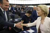 Germany's Ursula von der Leyen shakes hands with compatriot Manfred Weber after delivering her speech at the European Parliament in Strasbourg, eastern France, Tuesday July 16, 2019. Ursula von der Leyen outlined her vision and plans as Commission President. The vote, held by secret paper ballot, will take place later today. (AP Photo/Jean-Francois Badias)