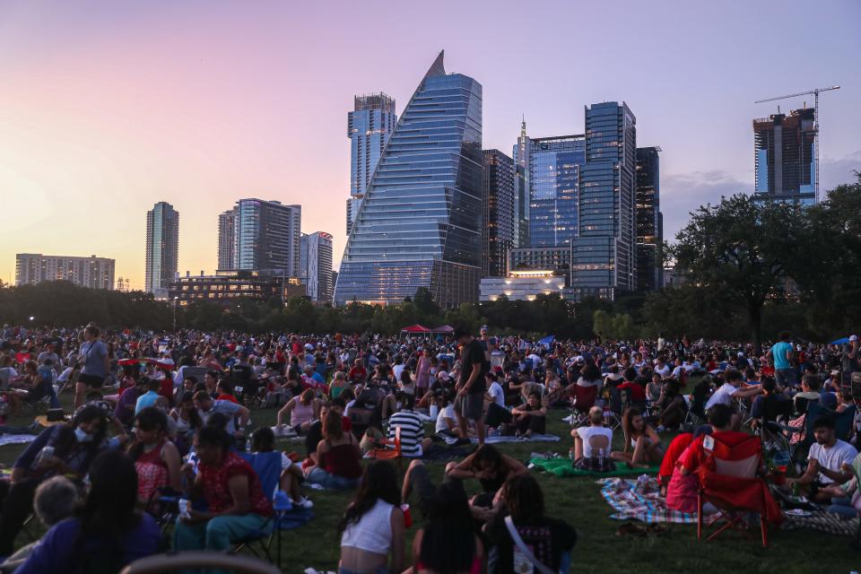 Austin residents pack the lawn at Auditorium Shores for the annual Fourth of July fireworks display in Downtown Austin, Texas