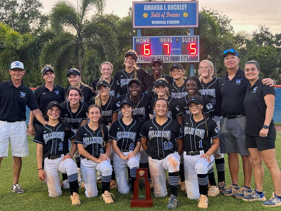 The Wellington softball team celebrates its come-from-behind win over Jupiter in the district championship game on May 4, 2023.