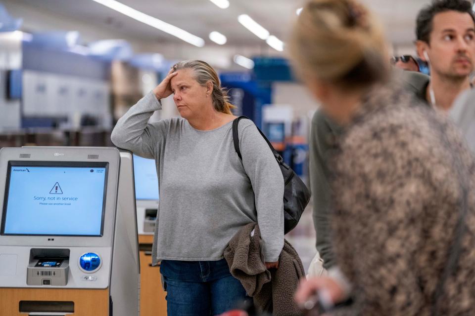 Passengers wait in line at Palm Beach International Airport in West Palm Beach, Florida on January 11, 2023. Thousands of flight delays and cancellations rippled across the U.S. after a computer outage led to a grounding order by the Federal Aviation Administration. 