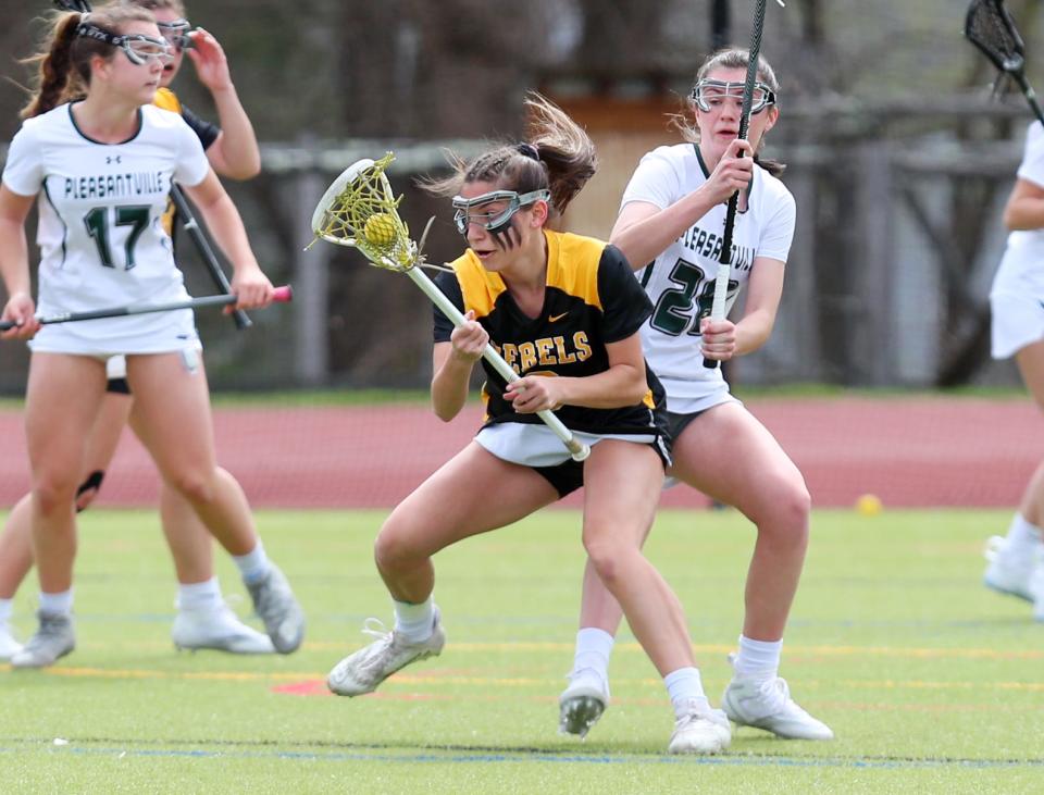 Lakeland/Panas' Isabel Kocaj (6) tries to drive to the goal in front of Pleasantville's Rowan Capko (28) during girls lacrosse action at Pleasantville High School April 7, 2023. Lakeland/Panas won the game 15-12.  