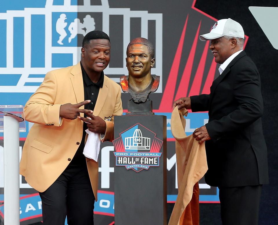 LeRoy Butler reacts to the unveiling of his bust along with his father -in-law Carlton Jordan during the Pro Football Hall of Fame induction ceremony held at Tom Benson Hall of Fame Stadium in Canton Ohio, Saturday, August 6, 2022. 