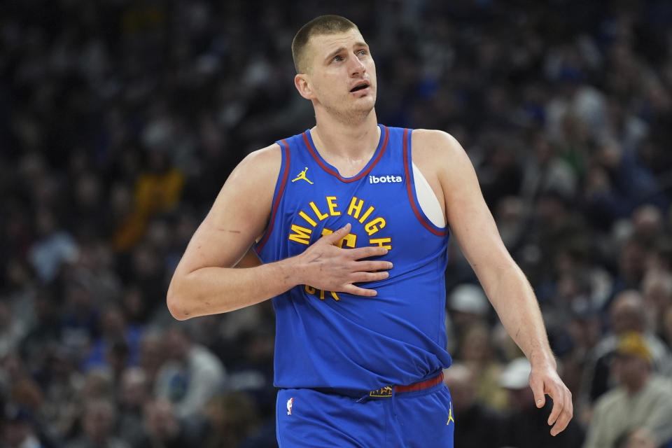 Denver Nuggets center Nikola Jokic walks across the court during the first half of an NBA basketball game against the Minnesota Timberwolves, Tuesday, March 19, 2024, in Minneapolis. (AP Photo/Abbie Parr)