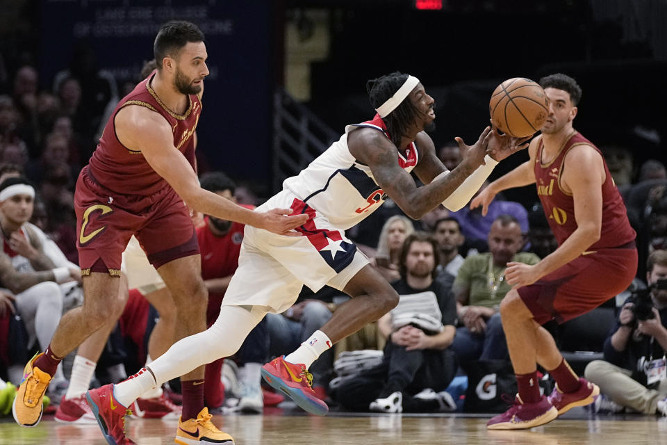 Washington Wizards guard Delon Wright, right, is fouled by Cleveland Cavaliers guard Max Strus, left, in the second half of an NBA basketball game Wednesday, Jan. 3, 2024 in Cleveland. (AP Photo/Sue Ogrocki)