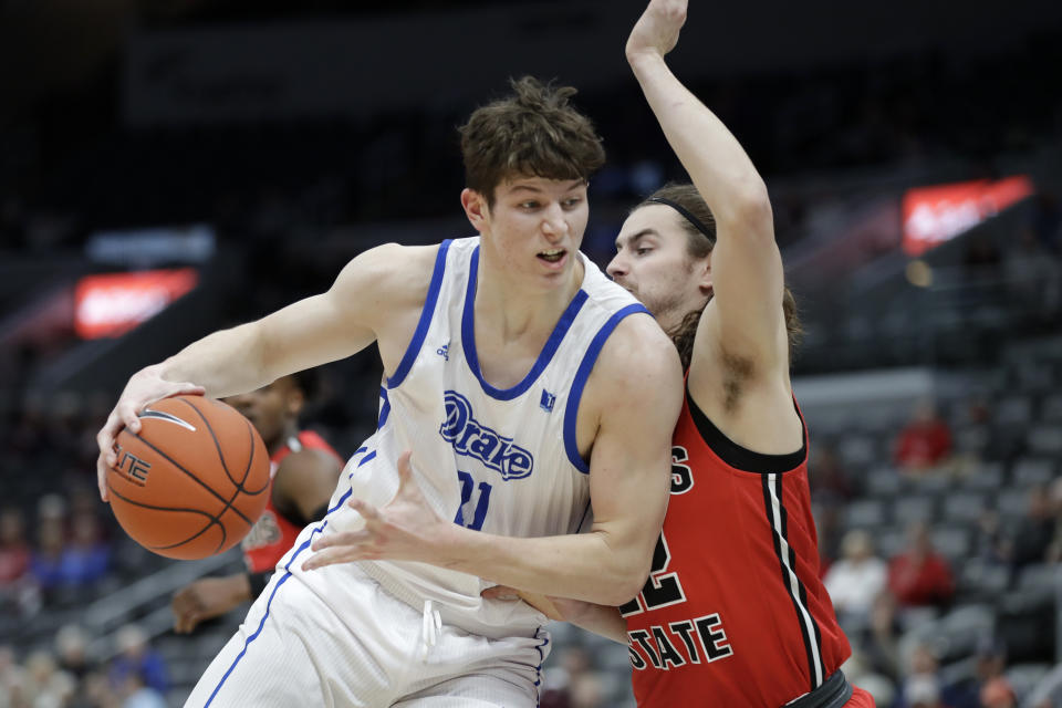 FILE - In this Thursday, March 5, 2020 file photo,Drake's Liam Robbins, left, heads to the basket as Illinois State's Matt Chastain defends during the first half of an NCAA college basketball game in the first round of the Missouri Valley Conference men's tournament in St. Louis. Minnesota transfer center Liam Robbins was granted immediate eligibility by the NCAA, the university announced Wednesday, Sept. 2, 2020. Robbins made the switch in April after two seasons at Drake.(AP Photo/Jeff Roberson, File)