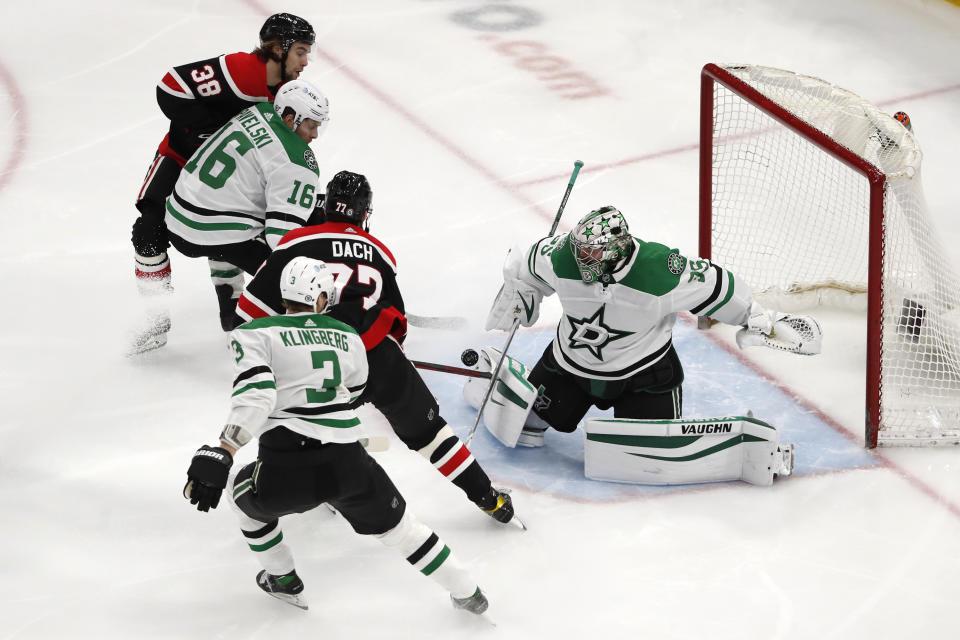 Dallas Stars goaltender Anton Khudobin (35) stops a shot by Chicago Blackhawks center Kirby Dach (77) during the second period of an NHL hockey game Thursday, April 8, 2021, in Chicago. (AP Photo/Jeff Haynes)