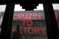 U.S. Republican presidential candidate Ted Cruz is seen through a window as he leaves a campaign event in Albia, Iowa, United States, January 26, 2016. REUTERS/Jim Young