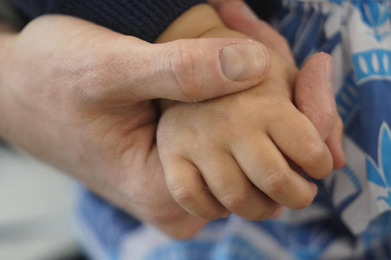 FILE - A mother holds her daughter's hand before her Moderna COVID-19 vaccination on June 21, 2022, in Salt Lake City. (AP Photo/Rick Bowmer, File)