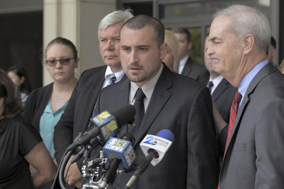 Widower Tim Caprio speaks, between father in-law Garry Sorrells, left, and Baltimore County State's Attorney Scott Shellenberger following the life sentence meted out for 17-year-old Dawnta Harris at Baltimore County Circuit Court Wednesday, Aug. 21, 2019, in Towson, Md. Harris was tried as an adult earlier this year and convicted of felony murder in the slaying of Baltimore County police Officer Amy Caprio. (Karl Merton Ferron/The Baltimore Sun via AP)