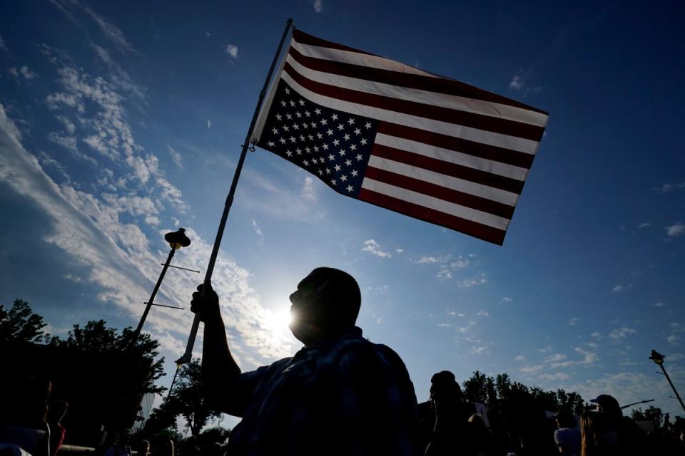 Abortion-rights protester Ryan Maher carries a flag during a march to the Iowa governor's mansion on Friday (Copyright 2022 The Associated Press. All rights reserved)