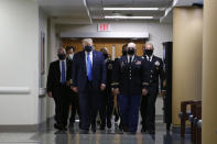 President Donald Trump wears a face mask as he walks down a hallway during a visit to Walter Reed National Military Medical Center in Bethesda, Md., Saturday, July 11, 2020. (AP Photo/Patrick Semansky)