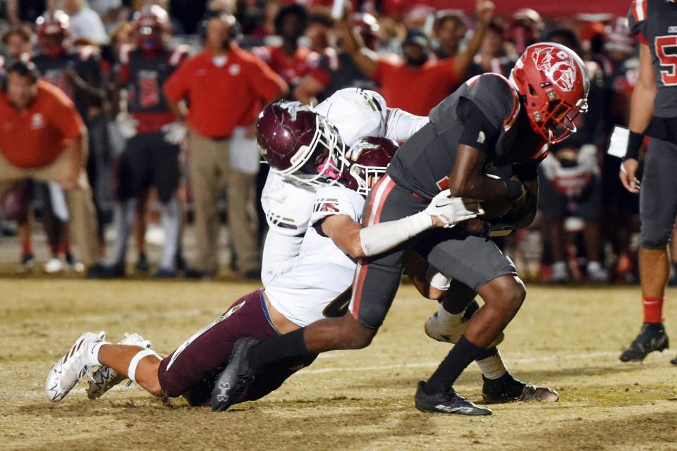 Crestview quarterback Jerome Brazen runs the ball with Niceville defenders Ramon Cruz and Christian Caballero in tow during a game held Friday, Sept. 30, 2022 in Crestview.