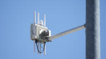 A radio transmitter hangs from a traffic light pole as it transmits to equipped commuter buses on Redwood Road, part of an effort to improve safety and efficiency by allowing cars to communicate with the roadside infrastructure and one another, Friday, Sept. 6, 2024, near Salt Lake City. (AP Photo/Rick Bowmer)