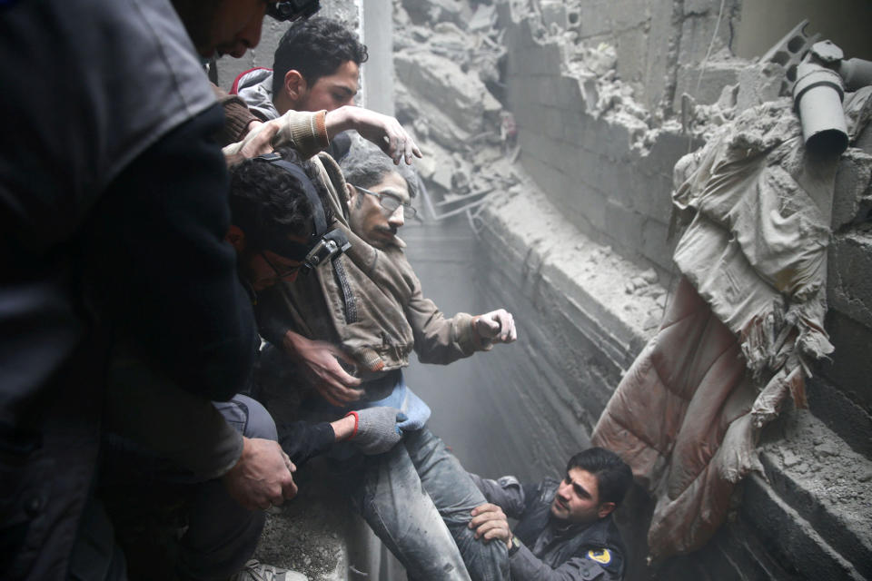 <p>Civil defence help a man from a shelter in the besieged town of Douma in eastern Ghouta in Damascus, Syria, Feb. 22, 2018. (Photo: Bassam Khabieh/Reuters) </p>