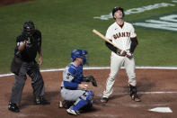 San Francisco Giants' Buster Posey, right, reacts after striking out next to Los Angeles Dodgers catcher Will Smith, middle, and umpire Doug Eddings (88) during the eighth inning of Game 5 of a baseball National League Division Series Thursday, Oct. 14, 2021, in San Francisco. (AP Photo/Eric Risberg)
