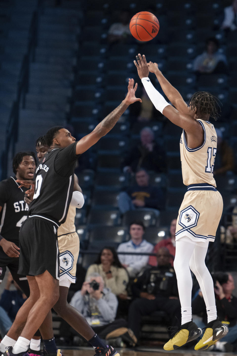 Georgia Tech guard Miles Kelly (13) shoots a three pointer against Mississippi State forward D.J. Jeffries (0) in the first half of an NCAA college basketball game Tuesday, Nov. 28, 2023, in Atlanta. (AP Photo/Hakim Wright Sr.)