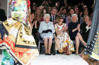 Britain's Queen Elizabeth II sits next to Vogue Editor-in-Chief Anna Wintour and Caroline Rush, Chief Executive of the British Fashion Council, and royal dressmaker Angela Kelly as they view Richard Quinn's runway show before presenting him with the inaugural Queen Elizabeth II Award for British Design as she visits London Fashion Week, in London, Britain February 20, 2018. REUTERS/Yui Mok/Pool