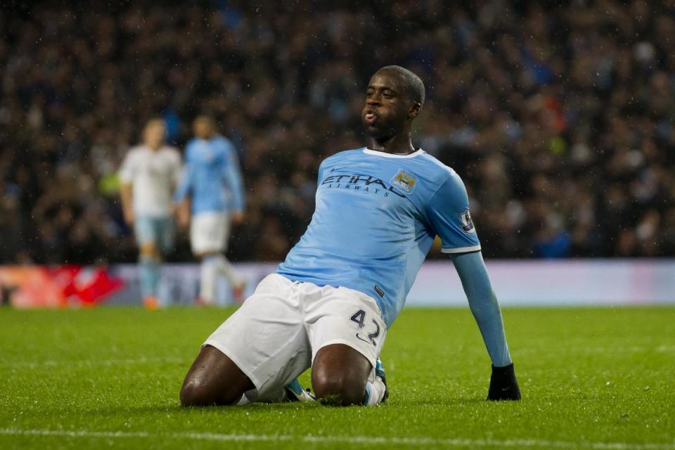 Manchester City's Yaya Toure celebrates after scoring against West Ham during their English League Cup semi-final soccer match at the Etihad Stadium, Manchester, England, Wednesday Jan. 8, 2014. (AP Photo/Jon Super)