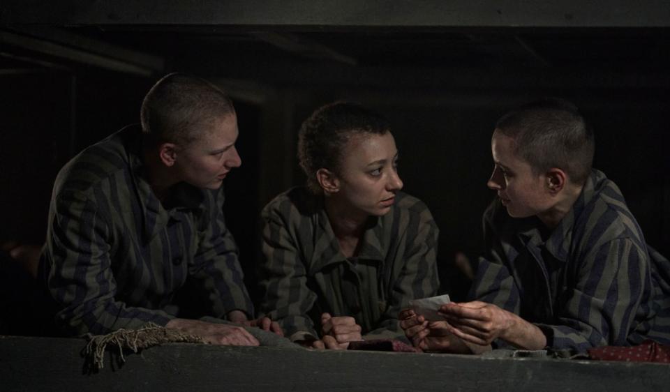 THE TATTOOIST OF AUSCHWITZ — Episode 102 — Pictured: (l-r) Tallulah Haddon as Hanna, Mili Eshet as Ivana, Anna Próchniak as Gita Furman in Auschwitz — (Photo by: Martin Mlaka/Sky UK)