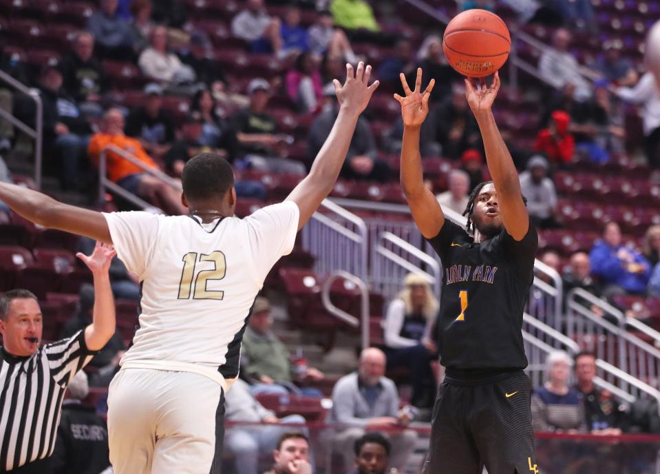 Lincoln Park's DeAndre Moye (1) shoots a three point shot after gaining space from Neumann-Goretti's Amir Ailliams (12) during the first half of the PIAA 4A Championship game Thursday night at the Giant Center in Hershey, PA.