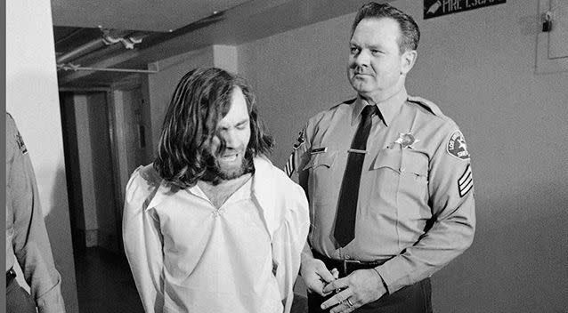 Cult leader Charles Manson, charged with murder and conspiracy in the slayings of actress Sharon Tate and six others, is escorted by a deputy sheriff after a court appearance at the Hall of Justice in Los Angeles in 1971. Photo: AP/Wally Fong