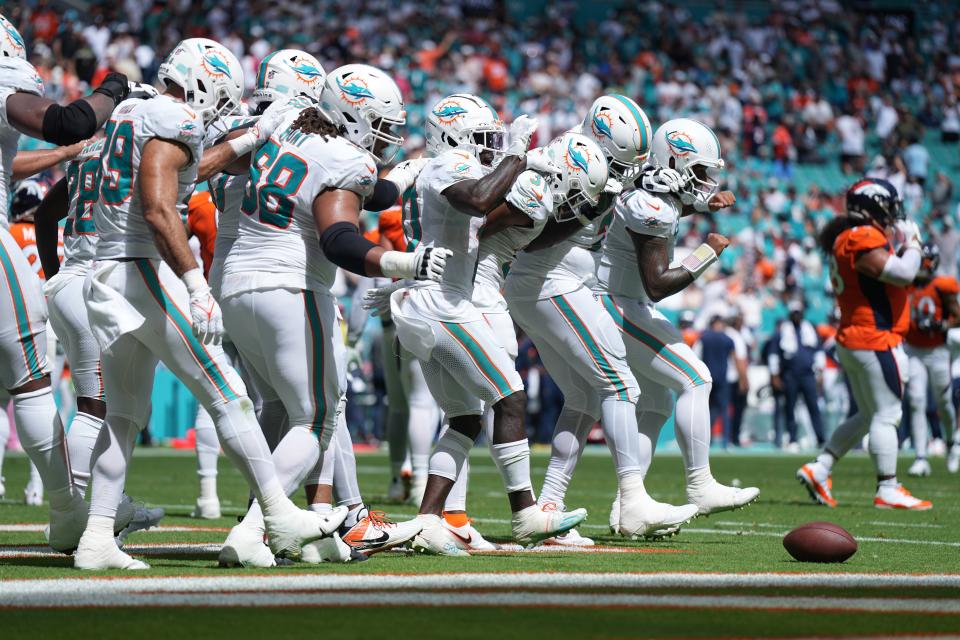 The Miami Dolphins offense does a dance routine after scoring against the Denver Broncos in the second quarter of an NFL game at Hard Rock Stadium in Miami Gardens, Sept. 24, 2023.