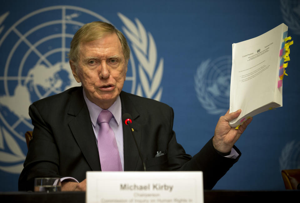 Retired Australian judge Michael Kirby, chairperson of the commission of Inquiry on Human Rights in the Democratic People's Republic of Korea, shows the commission's report during a press conference at the United Nations in Geneva, Switzerland, Monday, Feb. 17, 2014. A U.N. panel has warned North Korean leader Kim Jong Un that he may be held accountable for orchestrating widespread crimes against civilians in the secretive Asian nation. Kirby told the leader in a letter accompanying a yearlong investigative report on North Korea that international prosecution is needed "to render accountable all those, including possibly yourself, who may be responsible for crimes against humanity." (AP Photo/Anja Niedringhaus)