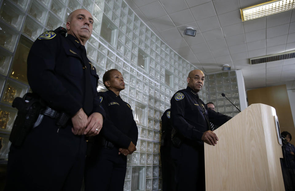 Bay Area Rapid Transit police chief Kenton Rainey, at podium, answers questions about the shooting of a BART officer who was killed by a fellow officer during a news conference Wednesday, Jan. 22, 2014, in Oakland, Calif. Authorities say a San Francisco Bay Area public transit officer who was shot and killed Tuesday by a fellow officer while searching an apartment was looking for a laptop and other stolen items. Rainey declined to disclose any further details of how the shooting of Sgt. Tom Smith occurred. A robbery suspect was in custody. (AP Photo/Eric Risberg)