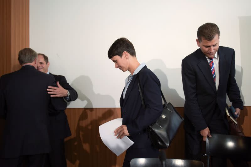 Frauke Petry, chairwoman of the anti-immigration party Alternative for Germany and Afd spokesman Christian Lueth leave a news conference in Berlin