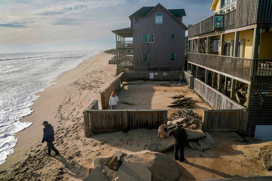 Amy and Tom Urban chat with longtime Outer Banks resident Carroll Midgett Sr. in their backyard, where there was once a swimming pool.