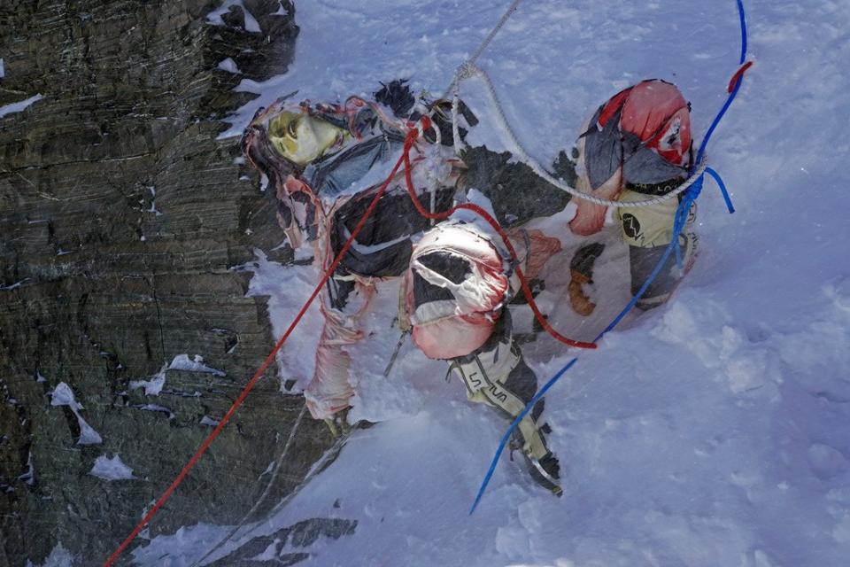 尼泊爾政府組織軍人和雪巴人從喜馬拉雅山上清運垃圾下山，圖為團隊找到、凍在冰中的登山者遺體。美聯社