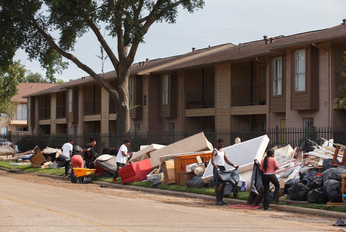 Workers sort through piles of flooded belongings at an apartment complex near Greens Bayou in the Greenspoint area of  Houston on Wednesday, Sept. 6, 2017, days after Tropical Storm Harvey dissipated.