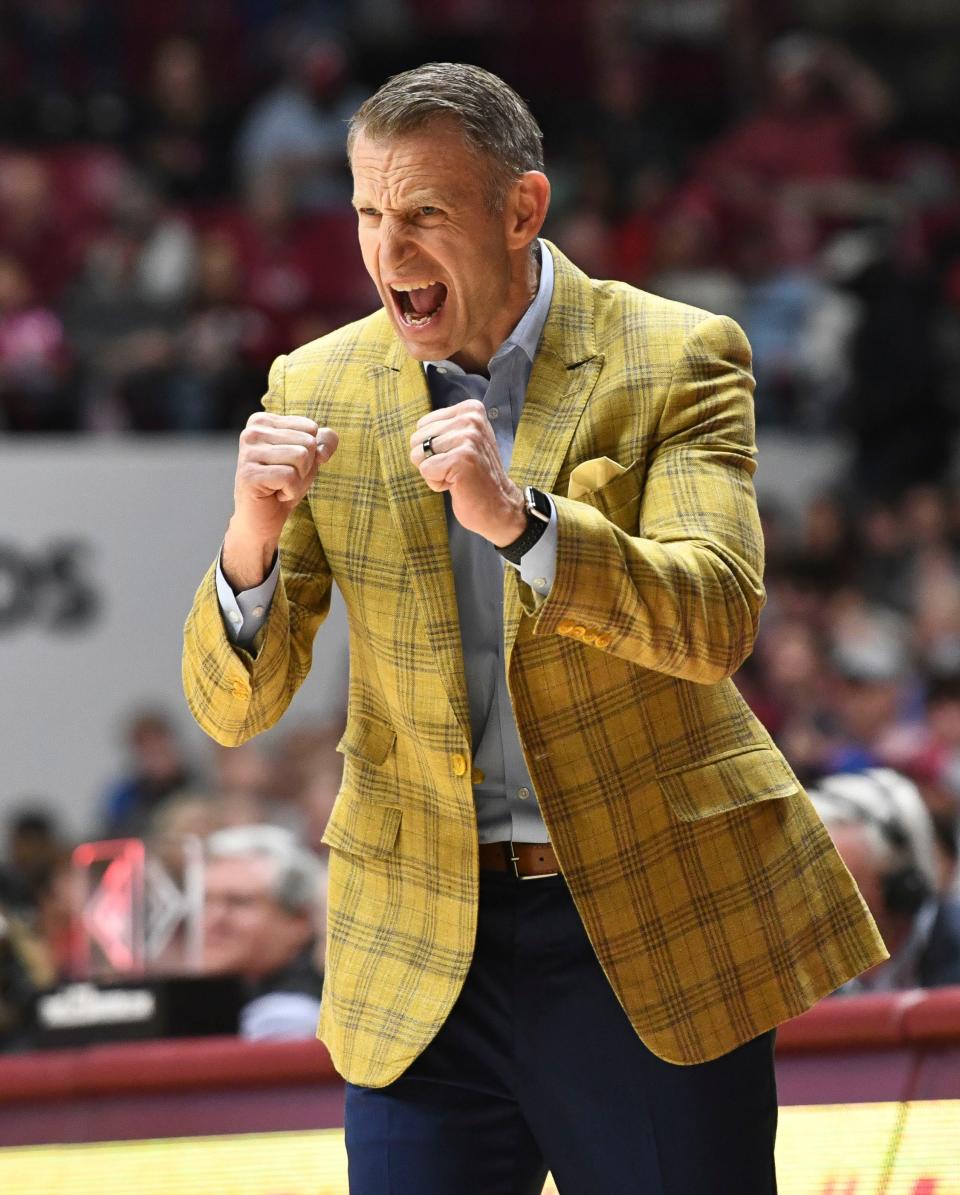 Feb 21, 2024; Tuscaloosa, Alabama, USA; Alabama head coach Nate Oats cheers on his team in the second half as the Crimson Tide mounted a comeback against the Florida Gators at Coleman Coliseum. Alabama came from behind to defeat Florida 98-93 in overtime. Mandatory Credit: Gary Cosby Jr.-USA TODAY Sports