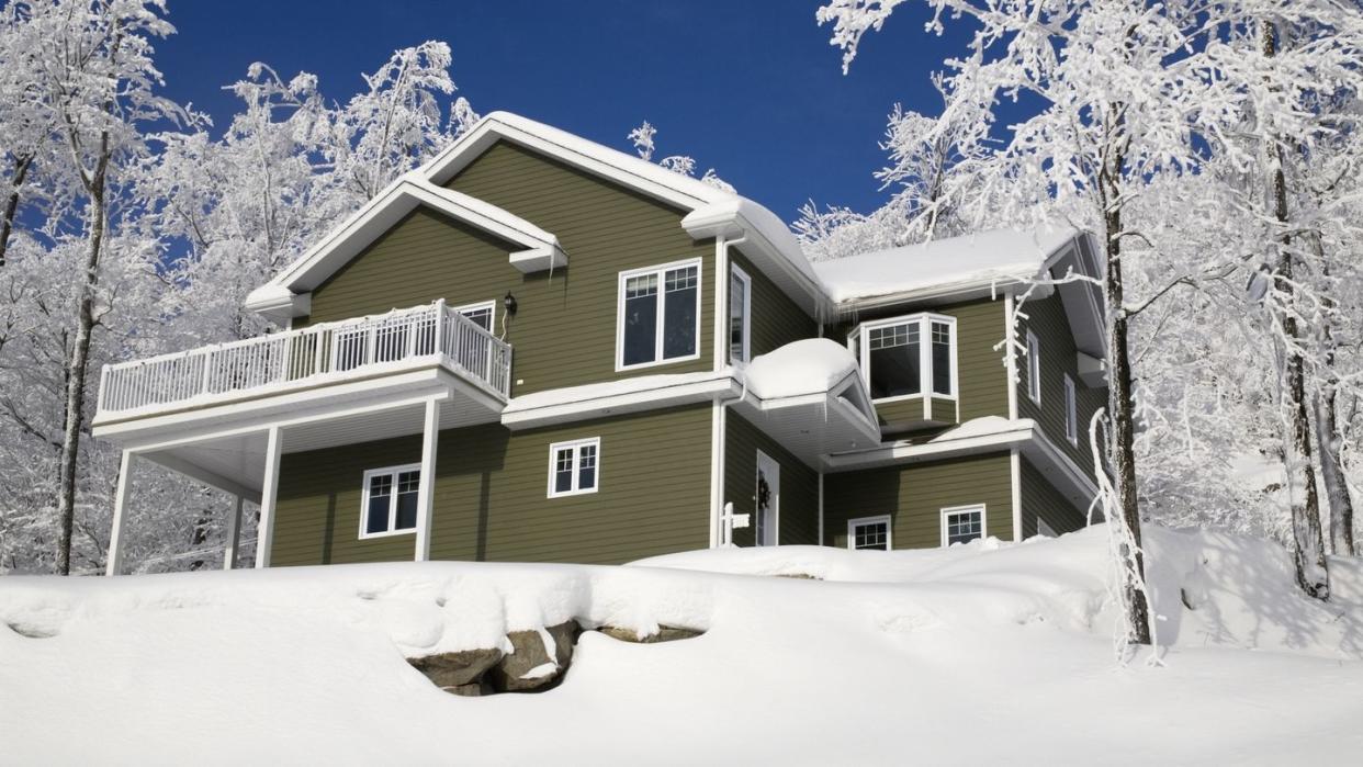 a house covered in snow in the winter