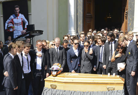Friends and Formula One drivers gather around the coffin of late Marussia F1 driver Jules Bianchi during the funeral ceremony at the Sainte Reparate Cathedral in Nice, France, July 21, 2015. REUTERS/Jean-Pierre Amet