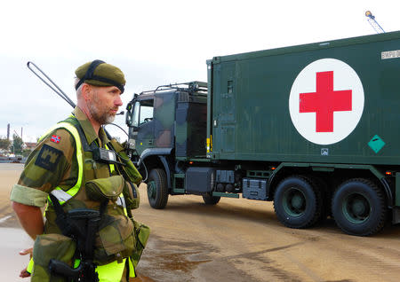 A Norwegian soldier stands guard as a German military vehicle is unloaded at Fredrikstad, Norway, September 7, 2018. REUTERS/Gwladys Fouche