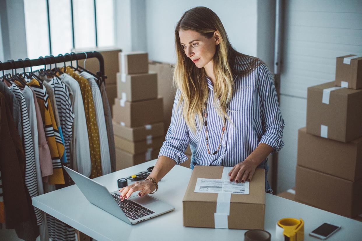 women, owner of small business packing product in boxes, preparing it for delivery