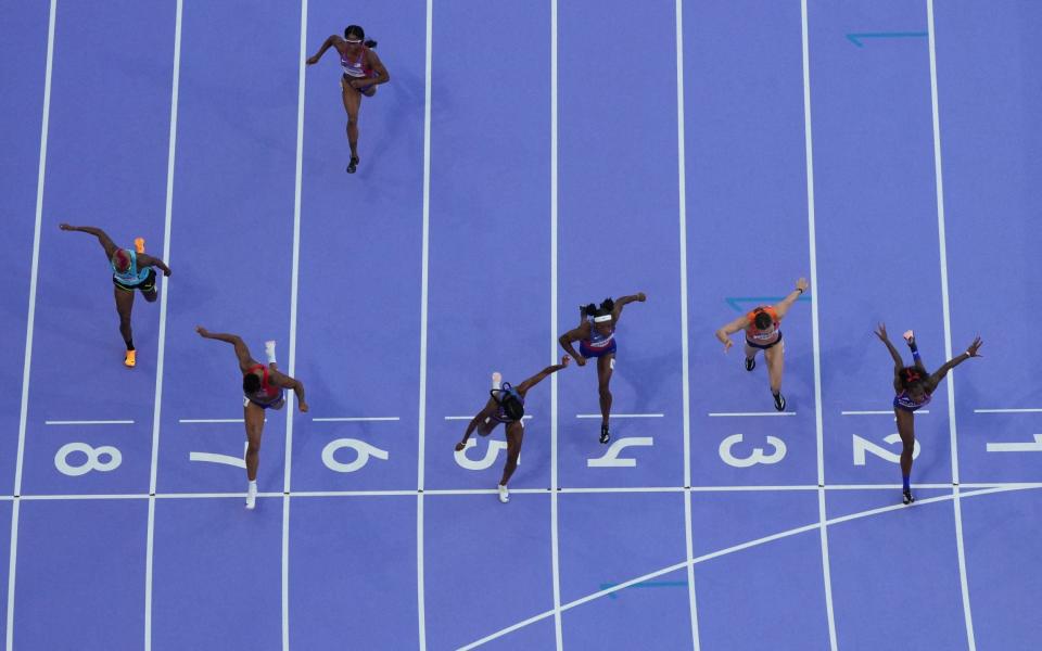 Masai Russell of United States crosses the line to win gold ahead of Cyrena Samba-Mayela of France and Jasmine Camacho-Quinn of Puerto Rico