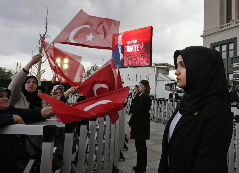 A veiled police officer stands guard during a rally by supporters of Turkey's President Recep Tayyip Erdogan, in Ankara, Turkey, Monday, April 17, 2017, one day after the referendum. Turkey's main opposition party urged the country's electoral board Monday to cancel the results of a landmark referendum that granted sweeping new powers to Erdogan, citing what it called substantial voting irregularities. (AP Photo/Burhan Ozbilici)