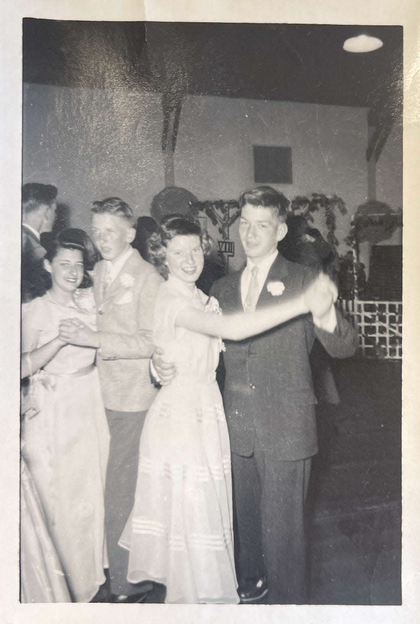 Black and white photo of two teenage couples dancing at prom in 1052.