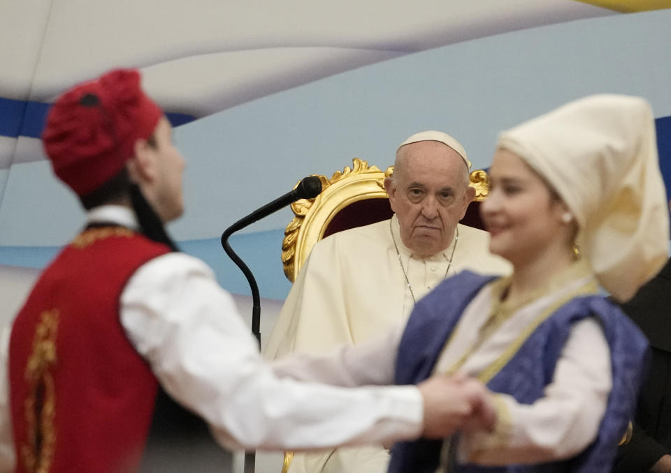 Pope Francis meets young people at the Saint Dionysius School of the Ursuline Sisters in Athens, Greece, Monday, Dec. 6, 2021. Francis' five-day trip to Cyprus and Greece has been dominated by the migrant issue and Francis' call for European countries to stop building walls, stoking fears and shutting out "those in greater need who knock at our door." (AP Photo/Alessandra Tarantino)